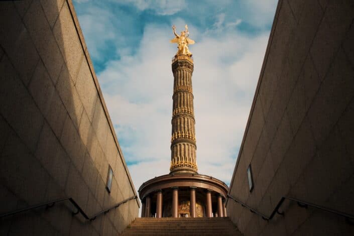 Gold statue on top of staircase.