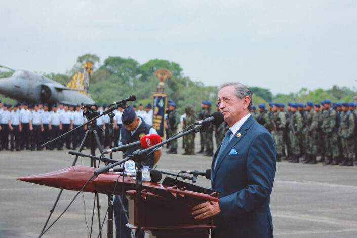 Man speaking to groups of uniformed personnel.