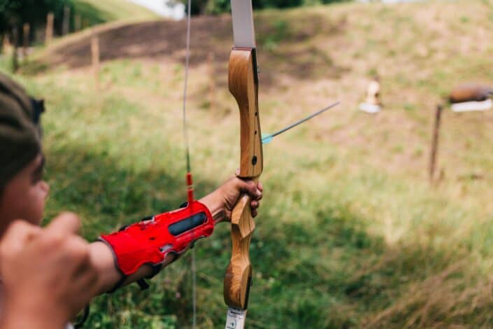 boy shooting a bow and arrow