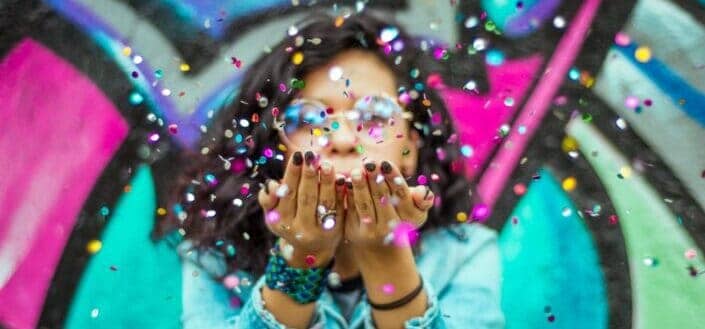 Woman blowing confetti