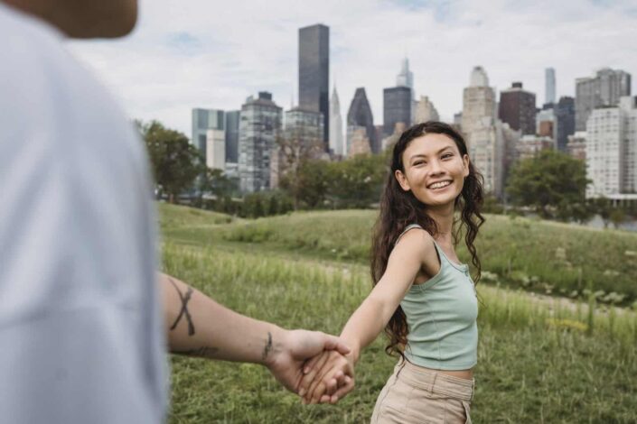 Smiling girl, holding hands with her guy.