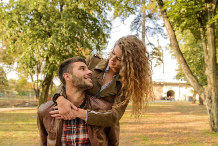 Girl embracing her guy from behind.