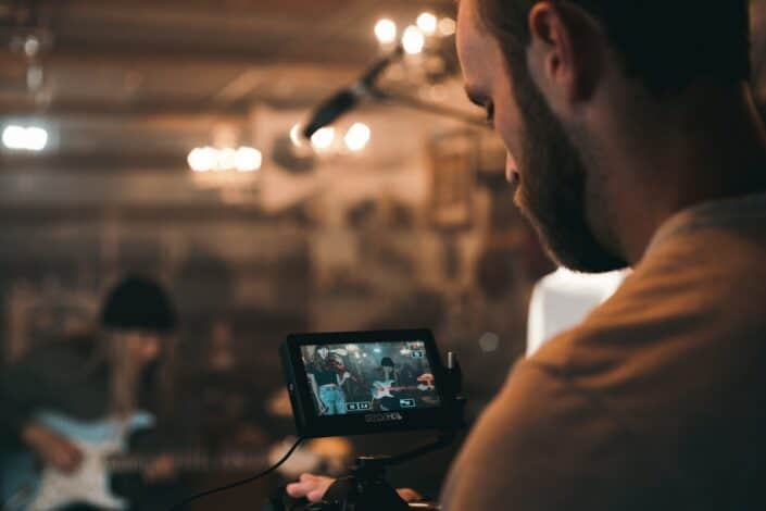 man holding a black video camera