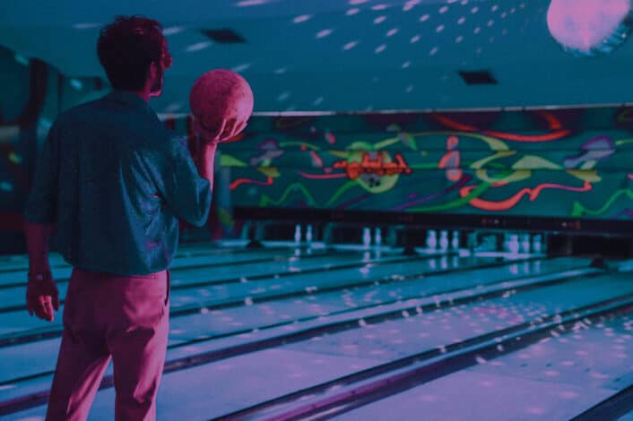 Unrecognizable man standing near bowling lane