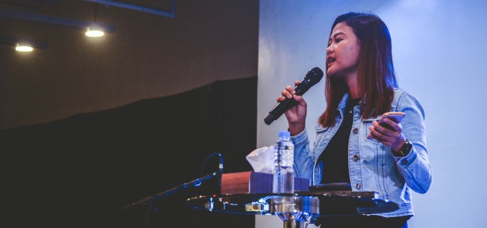 woman speaking on a podium