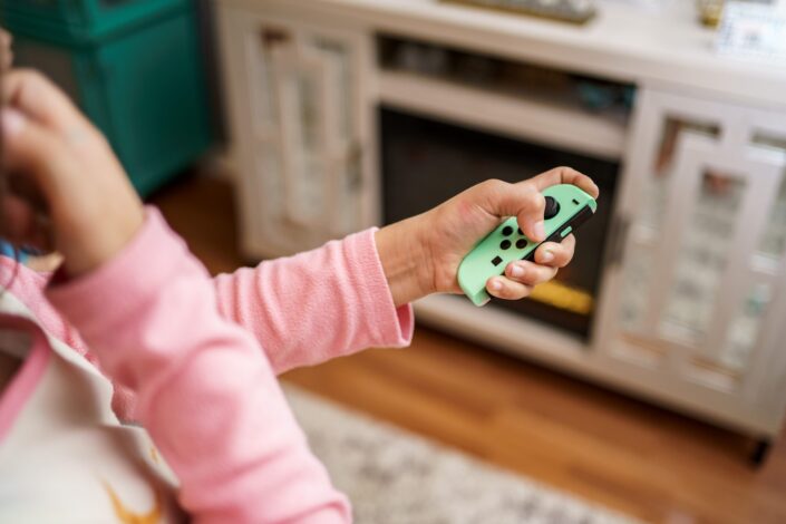 Girl playing with a Nintendo Switch controller
