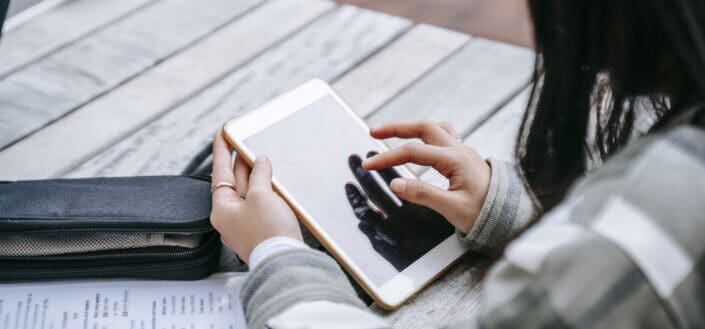 Girl tapping on the screen of her tablet