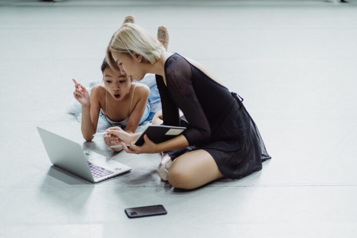 girls gasping in surprise in front of laptop