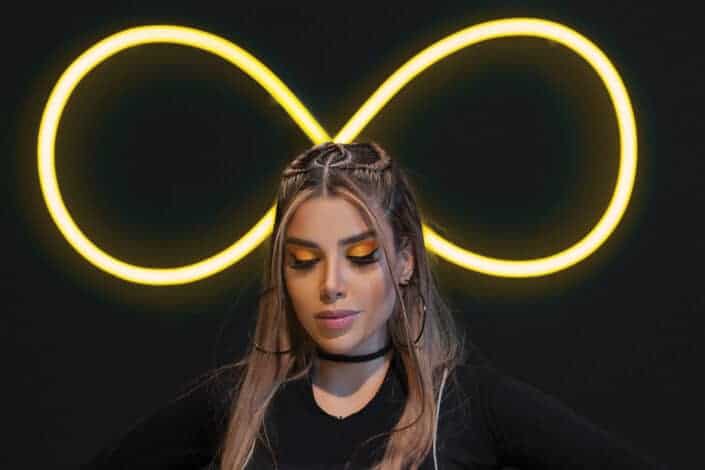 A woman with an infinity sign behind her