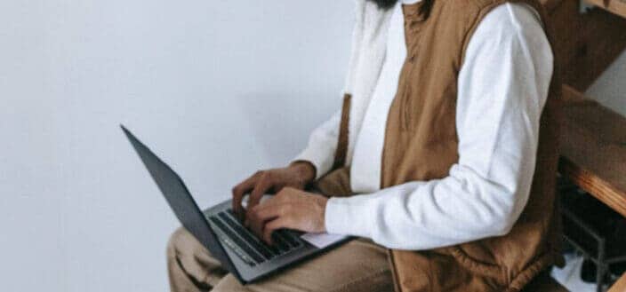 Guy typing on a laptop