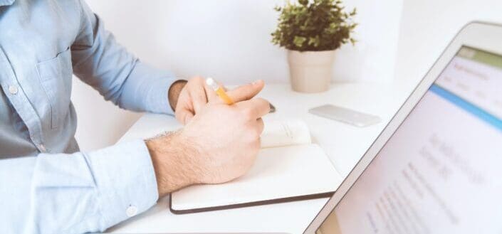 Businessman working and writing notes in his office