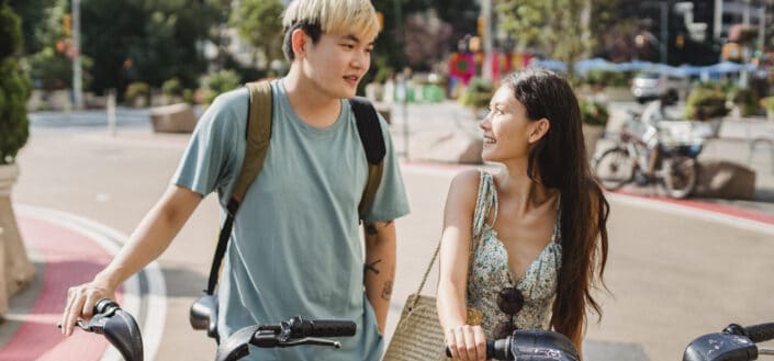 a couple holding bikes while talking