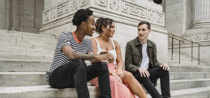 Three friends sitting on a staircase