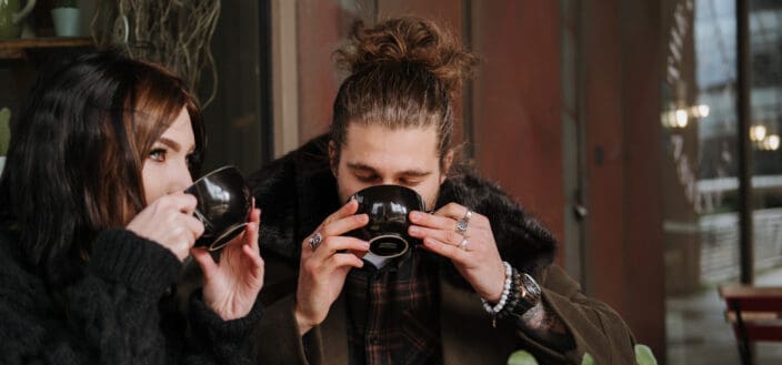 A man and a woman drinking coffee together