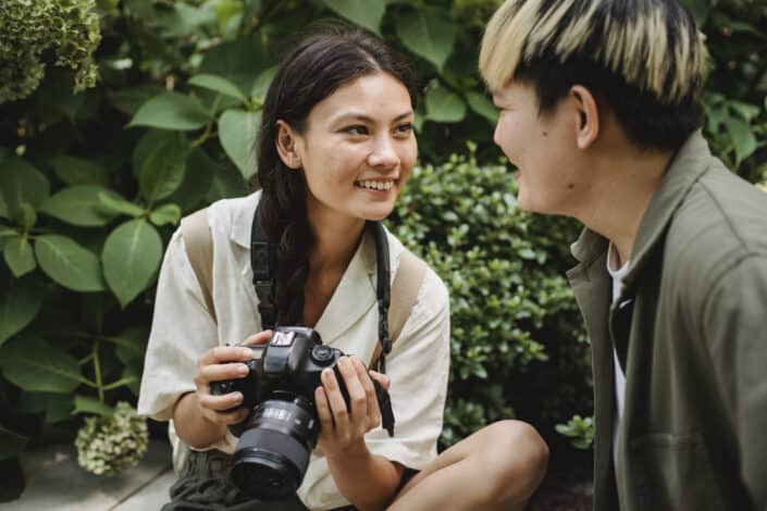 Couple talking near bushes on street