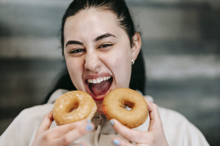 Woman holding two donuts