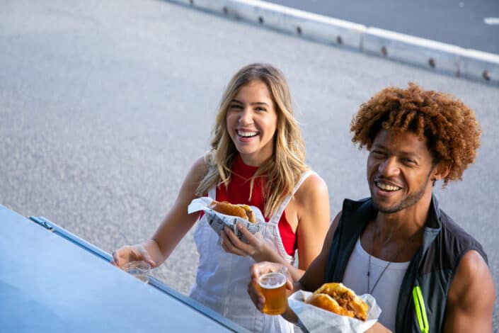 A couple eating burgers together