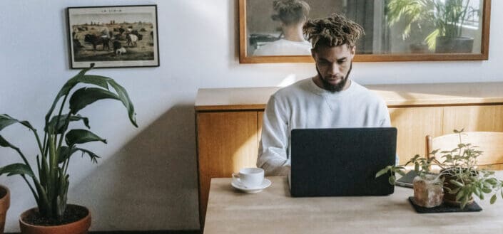 Man browsing laptop at home