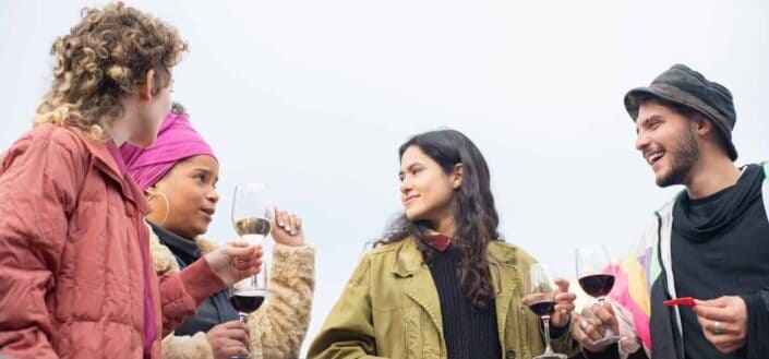 Friends Cheerfully Chatting While Drinking Wine