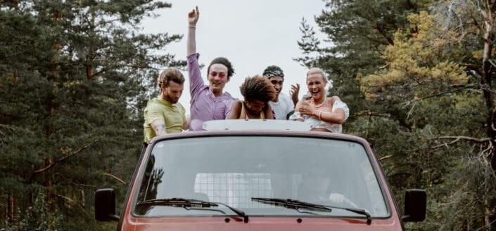 Group of friends standing behind pick up truck