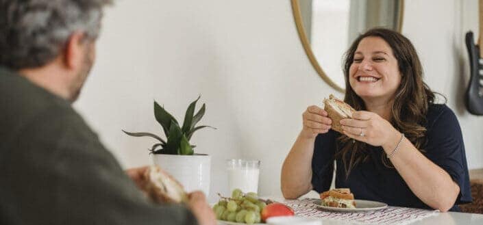 Happy couple enjoying breakfast together at home