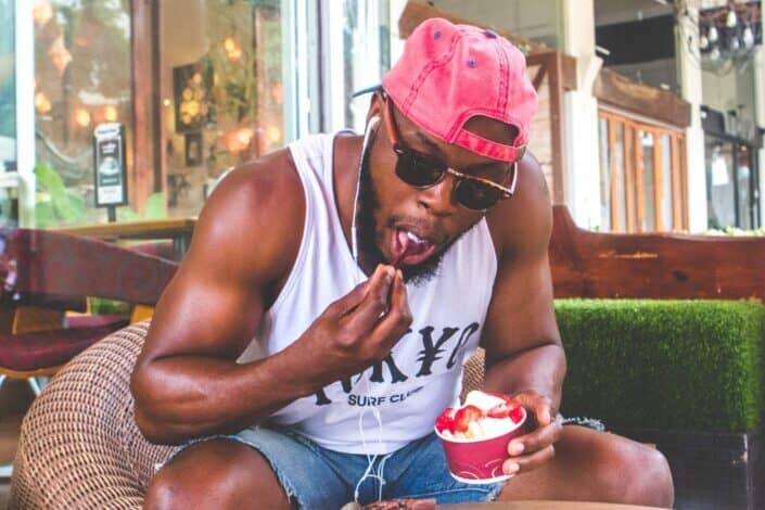 Man eating froyo with strawberries