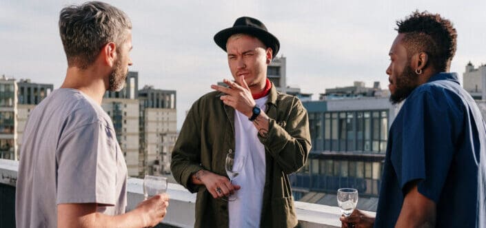 three friends talking on a rooftop