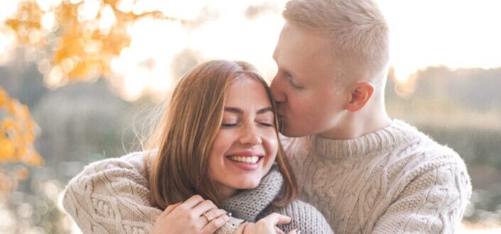 Man kissing and hugging woman