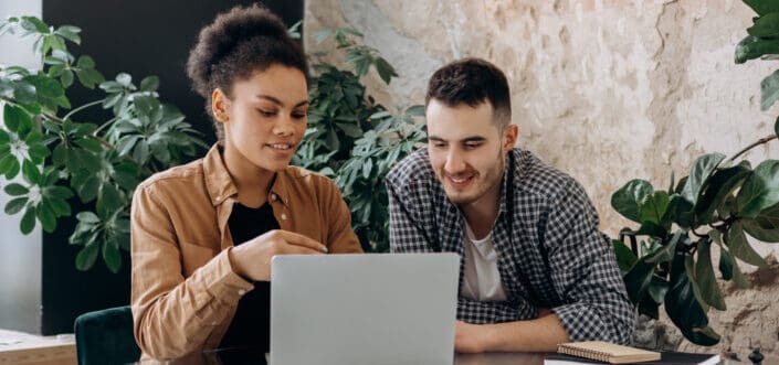 Man and woman looking at laptop