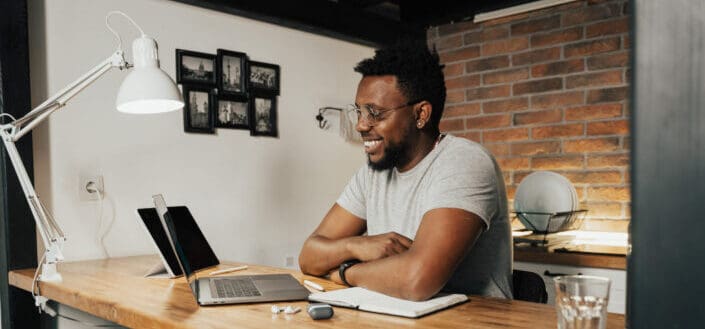 A happy man working on his laptop