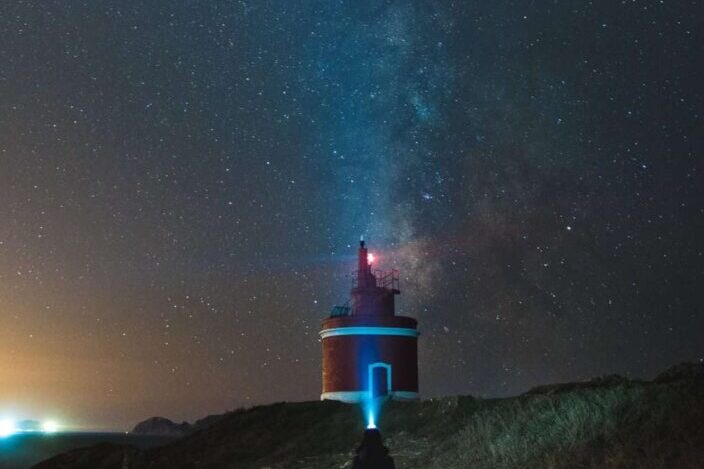 View of lighthouse under the beautiful night sky.