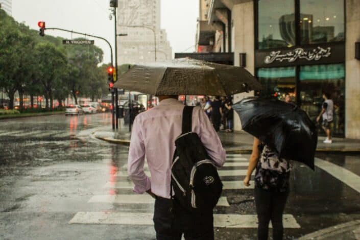 People on a pedestrian lane during a rainy day