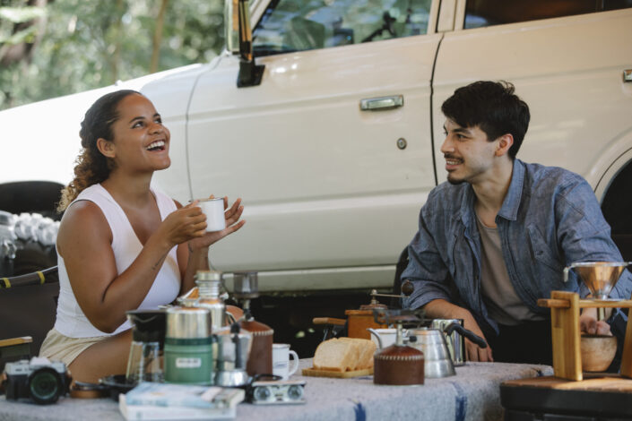 Two people laughing while having snacks