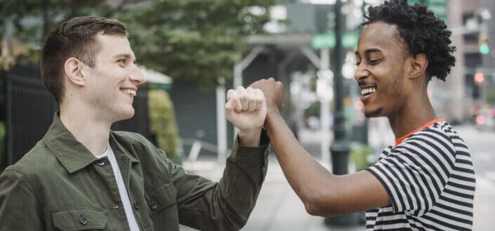 Two men with their fists bumped together