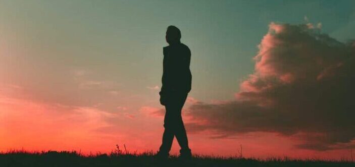 Person's silhouette on a pink-sky background.