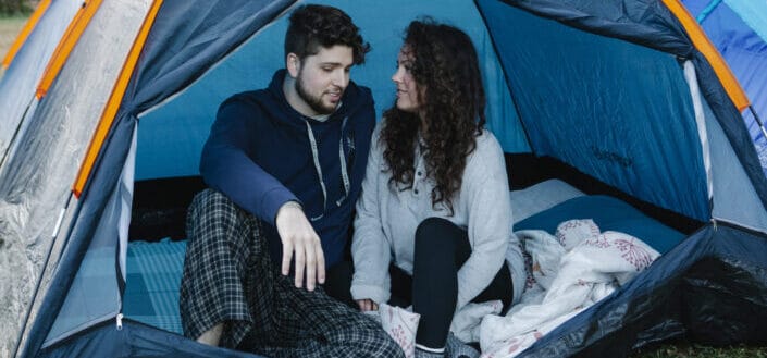 Couple talking inside a tent