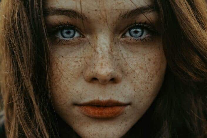 Woman with freckles and big blue eyes