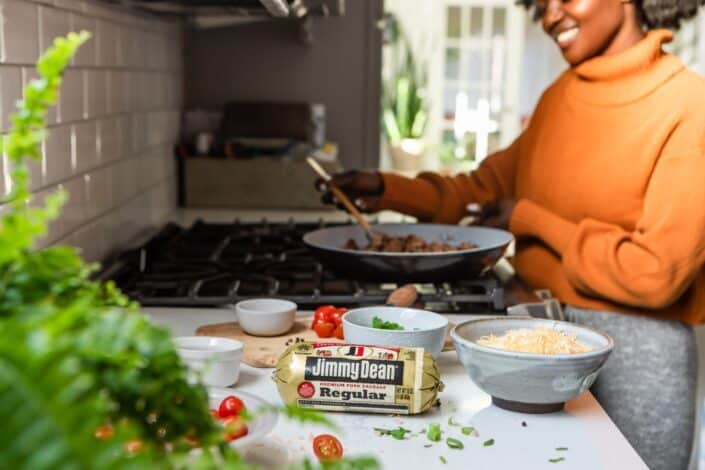 Woman in orange cooking