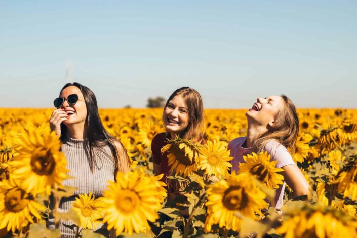 Friends in the middle of sunflower field