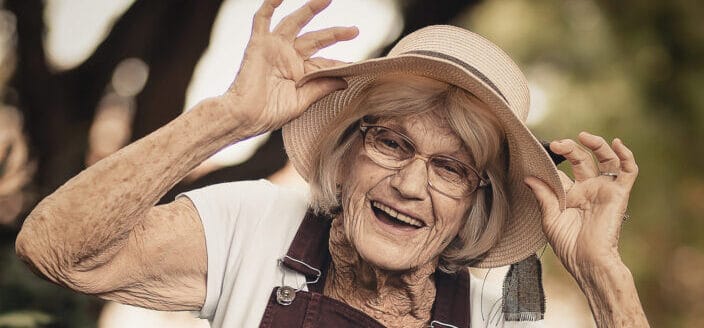 happy old woman wearing a hat