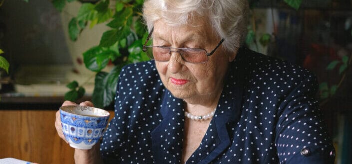 An old lady holding a teacup