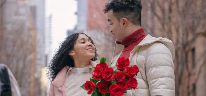 A couple with bunch of red roses