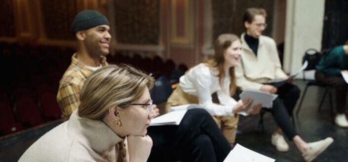 Group of people sitting with their scripts