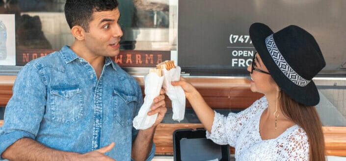 couple clinking sandwiches