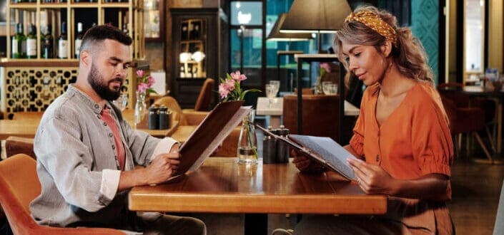 Man and woman sitting on chair in restaurant