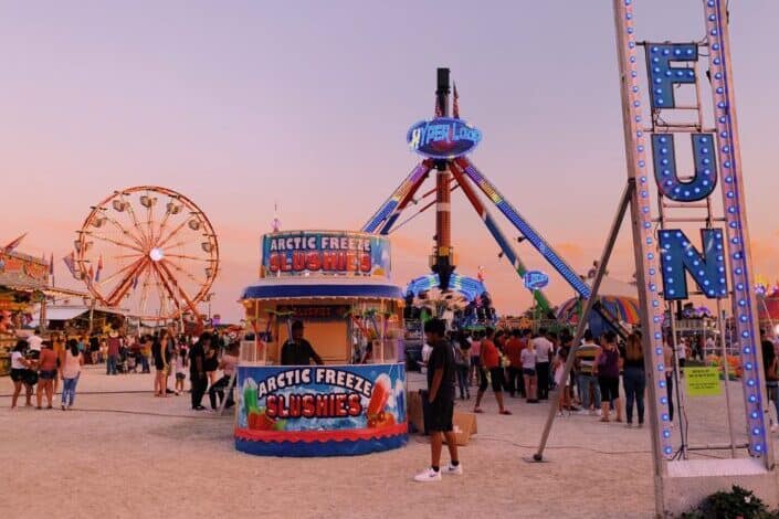 people in amusement park during daytime