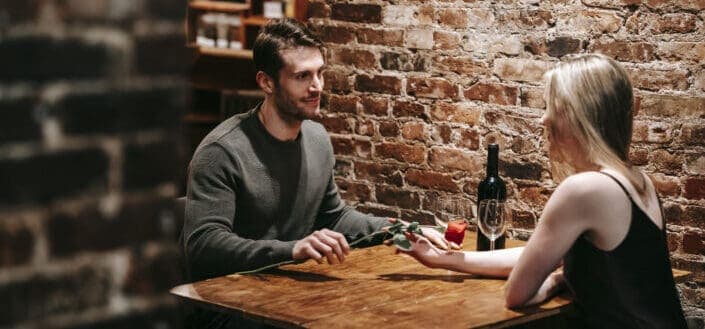 romantic couple having date with wine