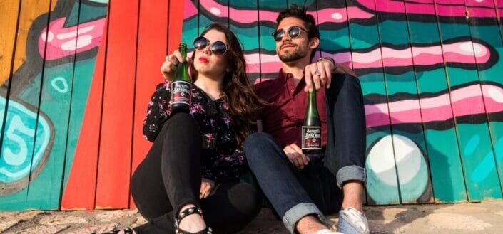 Sangria Senorial Couple relaxing in front of Mural