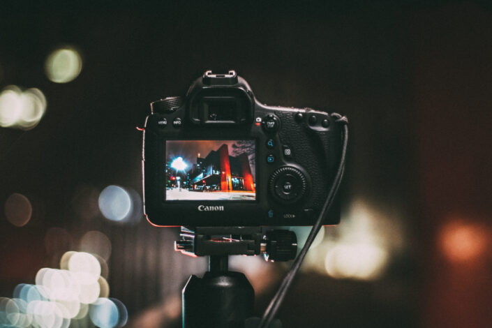 Selective focus photography of black canon camera