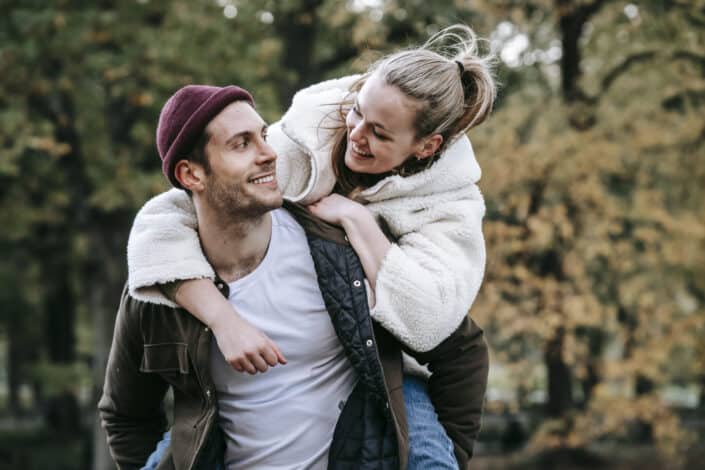 Man giving piggyback ride to a woman